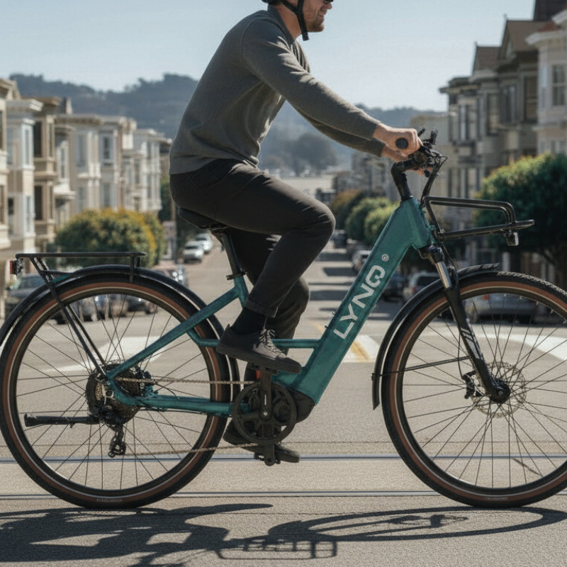 A rider cruises the LYNQ Current electric bike through the city in profile view.
